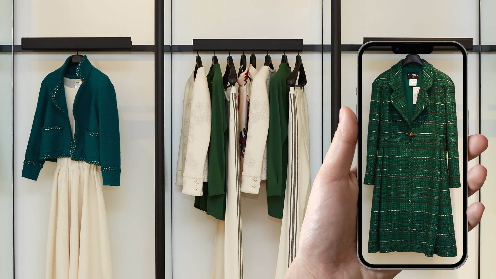 How visual search is transforming eCommerce Matrix Internet A hand holding a smartphone in front of a clothing rack, using visual search to identify a green coat in a store