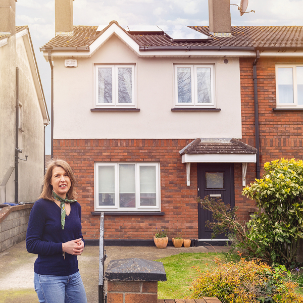 Woman beside a semi detached house