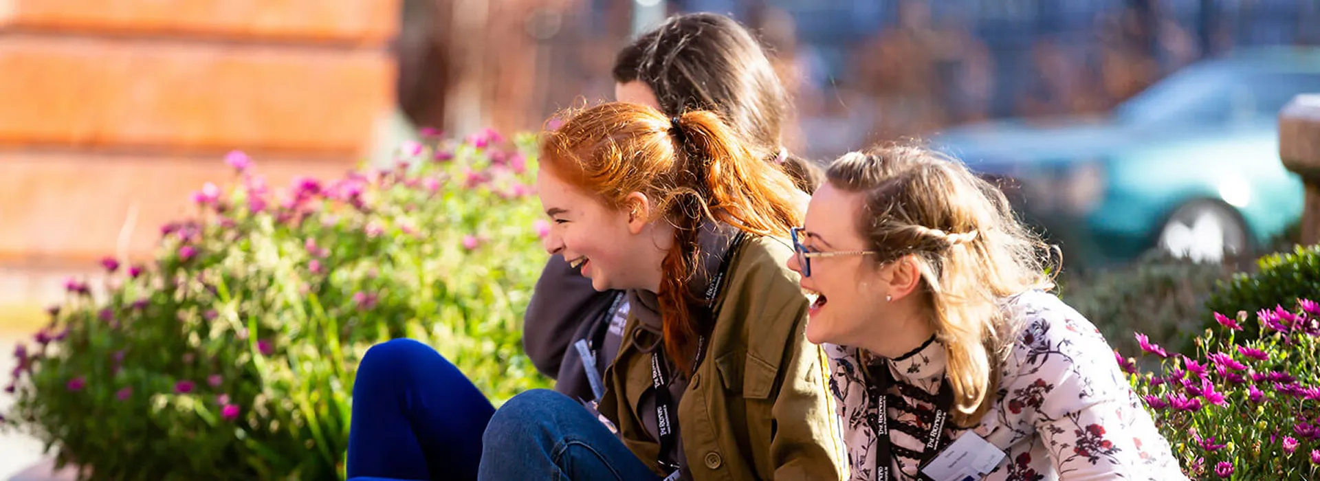 Two young women laughing outside together
